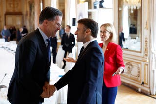 NATO Secretary -General Mark Rutt talks to Emmanuel Macron and EU foreign policy chief during the summit at the Egmont Palace in Brussels, Belgium